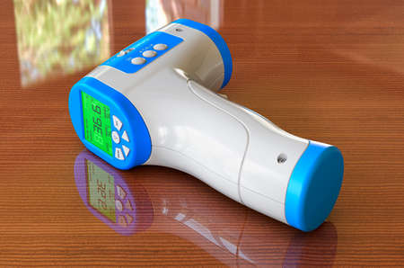 Digital Non-contact IR Infrared Thermometer on the wooden table. 3D renderingの写真素材
