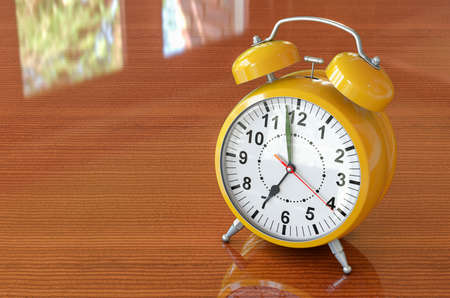Yellow alarm clock on the wooden table. 3D rendering
