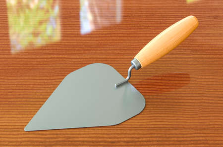 Masonry trowel on the wooden table, 3D renderingの写真素材