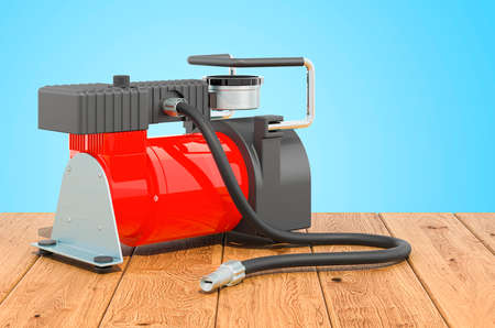 Car portable electric air compressor on the wooden table. 3D renderingの写真素材