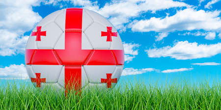 Soccer ball with Georgian flag on the green grass against blue sky, 3D renderingの写真素材