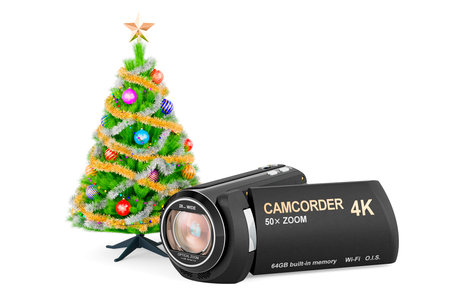 Christmas home video concept. Camcorder with Christmas tree. 3D rendering isolated on white backgroundの写真素材