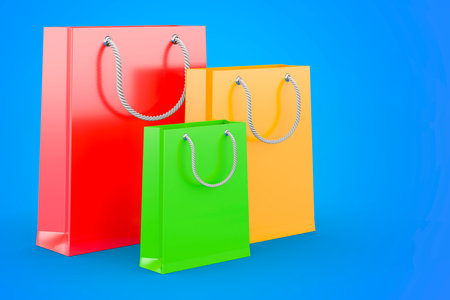 Shopping bags on blue background, 3D rendering isolated on blue backgroundの写真素材