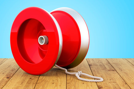 Yo-yo on wooden table, 3D renderingの写真素材