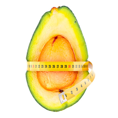 Avocado with measure tape around. Diet and weight loss concept. 3D rendering isolated on white backgroundの写真素材