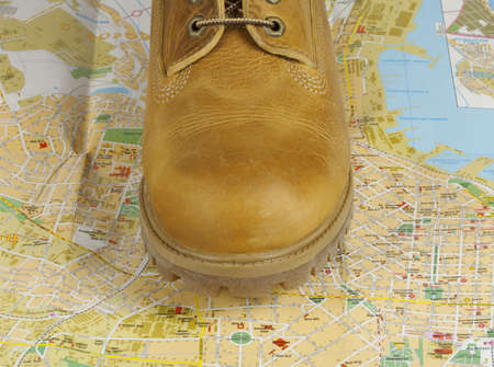 male yellow boots standing on a map