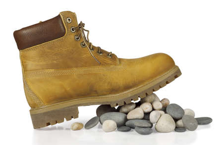 yellow boots on the stones isolated on white