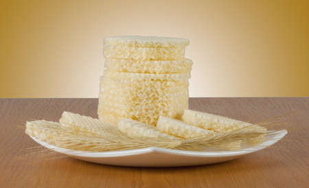 Fresh waffle with ears of wheat on a white plateの写真素材