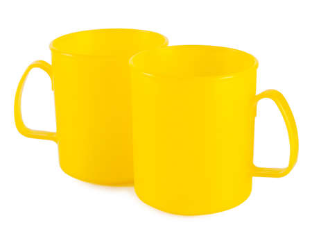 Two yellow cup isolated on white backgroundの写真素材