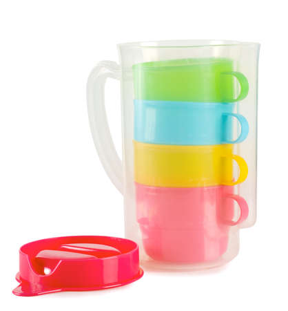 Four colorful cups with pitcher isolated on white backgroundの写真素材