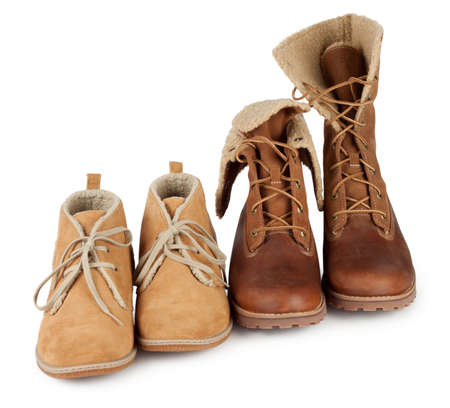 Leather boots standing in a row on a white backgroundの写真素材