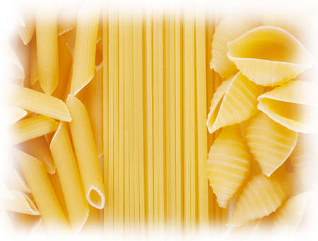 Background of spaghetti twisted and straight raw pastaの写真素材