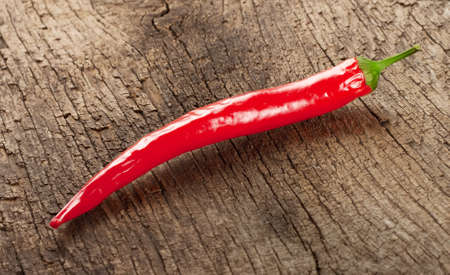 Red chili peppers on a wooden backgroundの写真素材