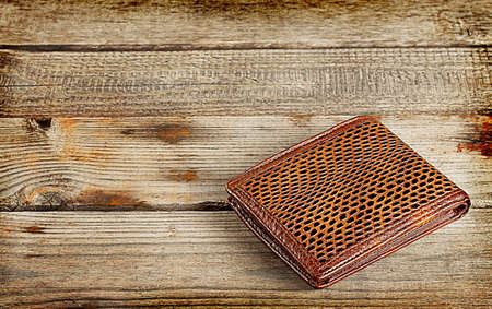 Brown leather wallet on a wooden backgroundの写真素材