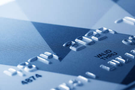 Fragment of credit card toned in blue colorの写真素材