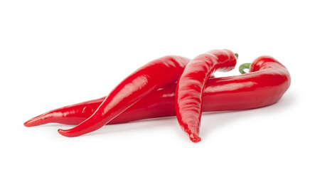 Three red hot peppers isolated on white backgroundの写真素材