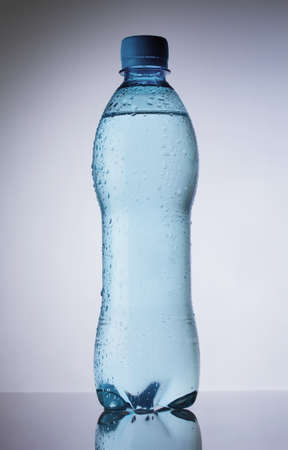 Bottle of pure water drops on gradient backgroundの写真素材