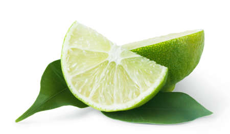 Slice of sour lime green with leaves isolated on white backgroundの写真素材