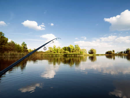 Landscape with lake and spinning in the background of treesの写真素材