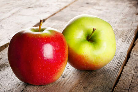 Juicy ripe apples on a wooden backgroundの写真素材