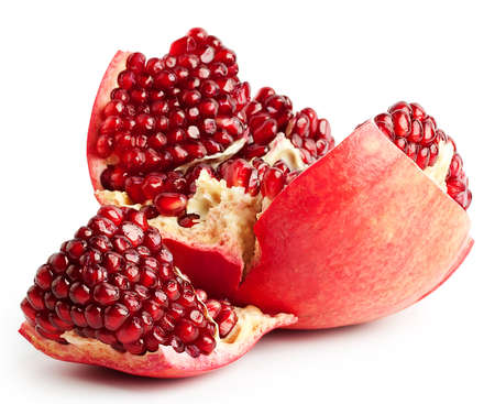 Broken mid pomegranate with seeds isolated on white backgroundの写真素材
