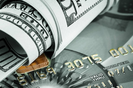 Background of dollars and bank cards tinted greenの写真素材