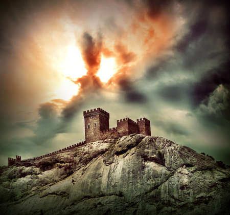 Ancient fortress on the hill under dramatic skyの写真素材