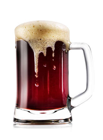 Mug thick dark beer with foam isolated on white backgroundの写真素材