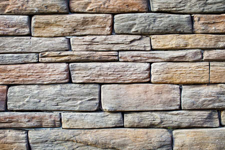 Background of wall with rough solid stone arranged in layers