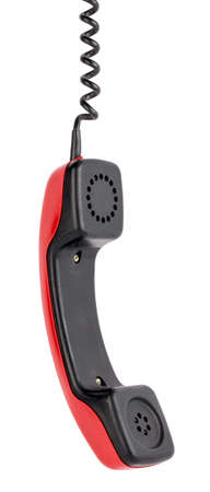 Red handset is hanging on wire isolated on white backgroundの写真素材
