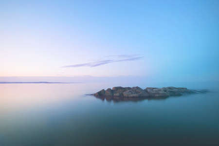 Lonely island in the lake foggy morningの写真素材