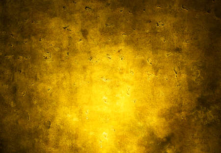 Background of textured wall with yellow spot lightの写真素材