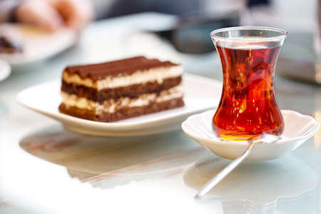 Glass of tea and cake on the table in cafe