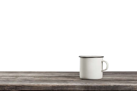 White mug on wooden table isolated on white backgroundの写真素材