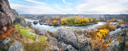 Panorama of mountain river among stones in autumnの写真素材