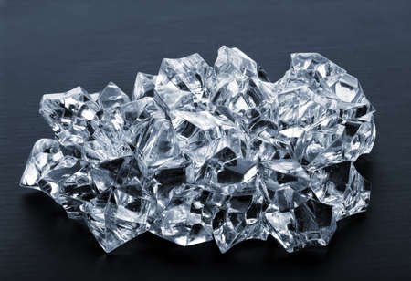 Pile of ice cubes on a black backgroundの写真素材