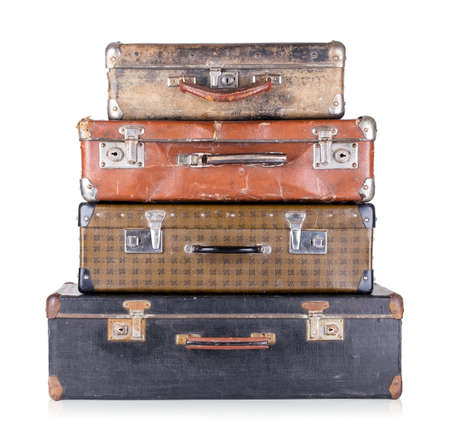 A stack of old suitcases isolated on white backgroundの写真素材