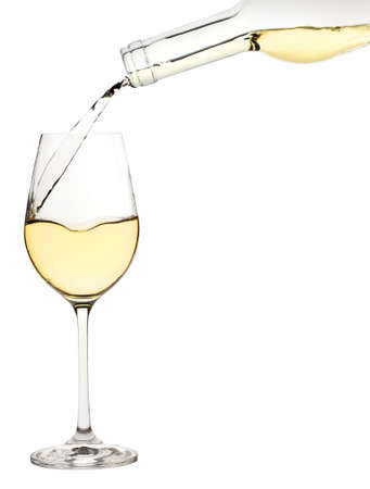 Glass of white wine is poured from a bottle isolated on a white backgroundの写真素材