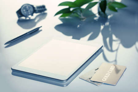 Business still-life with flower shot with selective focus and toned. Logos, buttons removed. The original size of the tablet PC is changed.の写真素材