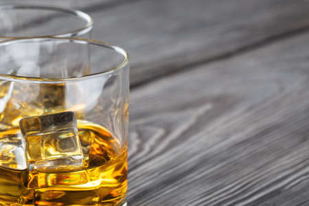 Fragment of two glasses of whiskey with iceの写真素材