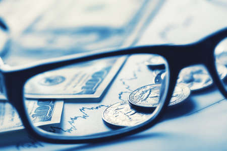 Business still-life with glasses dollars and scheduleの写真素材