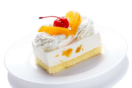 Piece of a delicious cake on a plate isolated on a white backgroundの写真素材