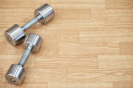 Two metal dumbbells on the floorの写真素材