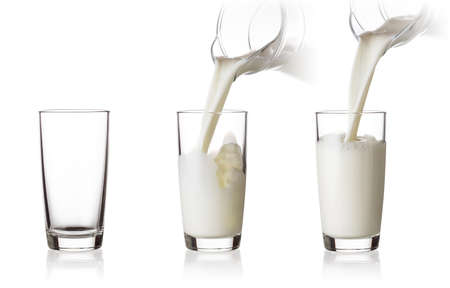 Process of filling a glass of milk from jugの写真素材