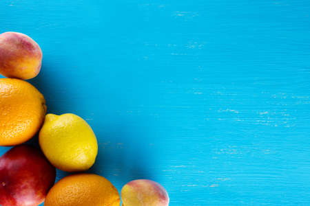 Fresh raw fruits on a blue wooden background