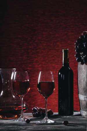 Wine still life with wine in glasses and grapes on a wooden tablの写真素材
