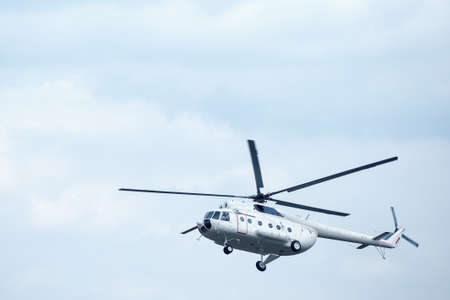 White helicopter in the blue skyの写真素材