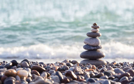 Pyramid of sea stones on pebbles of the sea shoreの写真素材