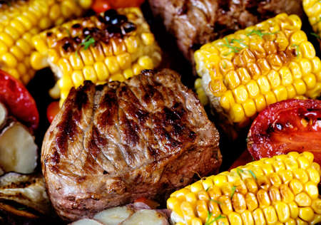 Food background of baked meat, corn and vegetables. The concept of healthy natural food. Traditional...