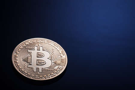 Golden bitcoin on a dark blue background